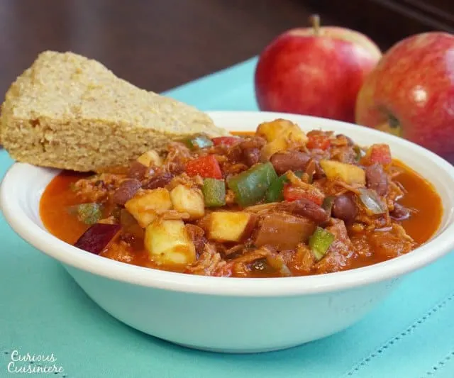 This Pulled Pork Chili uses fresh ingredients to give it a sweet and spicy flavor. You'd never guess it was an apple chili! | www.CuriousCuisiniere.com