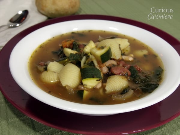 Our Crock Pot Minestrone is not a wimpy soup. Full of chunky vegetables and laden with herbs, this is some serious comfort food made easy in your slow cooker. | www.curiouscuisiniere.com