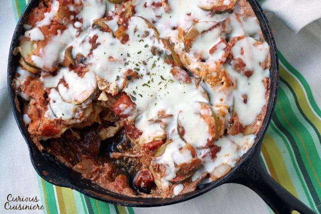 Overhead vegetarian lasagna with a portion removed.