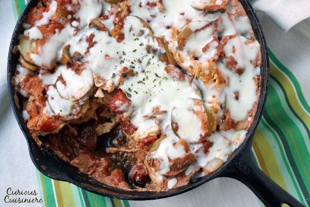 Overhead vegetarian lasagna with a portion removed. 