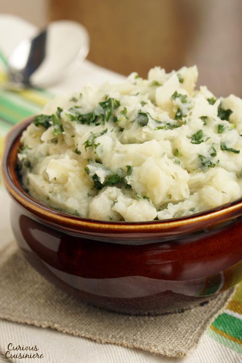 Irish Colcannon brings mashed potatoes to a whole new level with flavorful onions and nutritious cabbage. These Irish mashed potatoes are the perfect way to sneak extra veggies into your meal! | www.CuriousCuisiniere.com