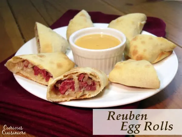 All the sandwich flavor in a little hand-held bundle, these Baked Reuben Egg Rolls are the perfect recipe for St. Patrick's day and beyond! | www.CuriousCuisiniere.com