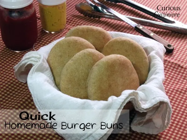 These homemade hamburger buns go from a pile of ingredients to fluffy, golden buns in less than an hour. | www.CuriousCuisiniere.com
