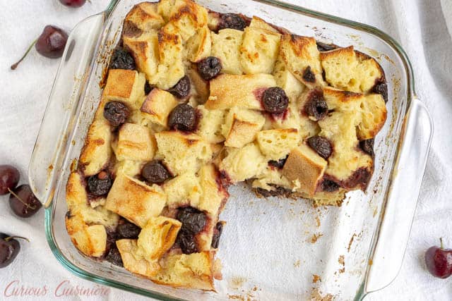 A balsamic glaze gives this cherry bread pudding an unexpected burst of bright flavor. This recipe is the perfect way to use stale bread and makes a wonderful breakfast or dessert! | www.CuriousCuisiniere.com