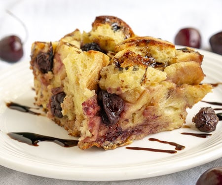 A balsamic glaze gives this cherry bread pudding an unexpected burst of bright flavor. This recipe is the perfect way to use stale bread and makes a wonderful breakfast or dessert! | www.CuriousCuisiniere.com