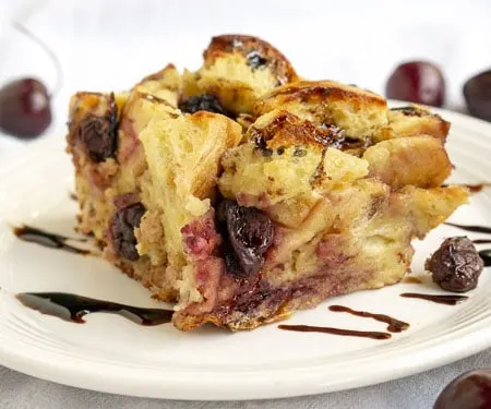 A balsamic glaze gives this cherry bread pudding an unexpected burst of bright flavor. This recipe is the perfect way to use stale bread and makes a wonderful breakfast or dessert! | www.CuriousCuisiniere.com