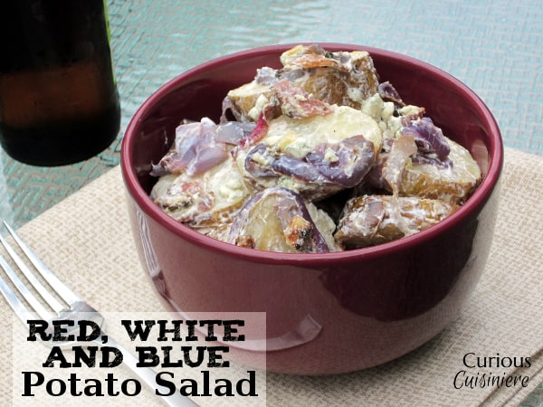 This healthy potato salad with yogurt, red onions, blue cheese, bacon, and roasted potatoes is big on creamy flavor but light on calories! | Curious Cuisiniere