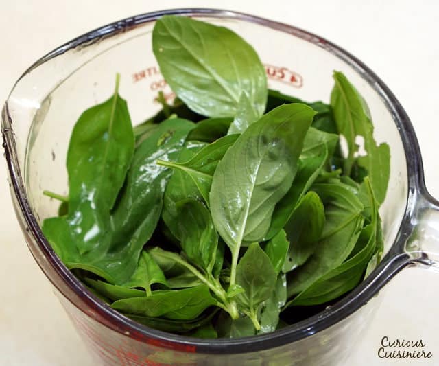 You don't have to wait until summer's harvest to enjoy fresh basil pesto! This basic pesto recipe is perfect for freezing so you can enjoy it all year long. | www.CuriousCuisiniere.com