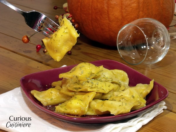 Pumpkin infused pasta makes the perfect vessel for a creamy tarragon-spiced cheese filling in this pumpkin ravioli recipe. | www.curiouscuisiniere.com 