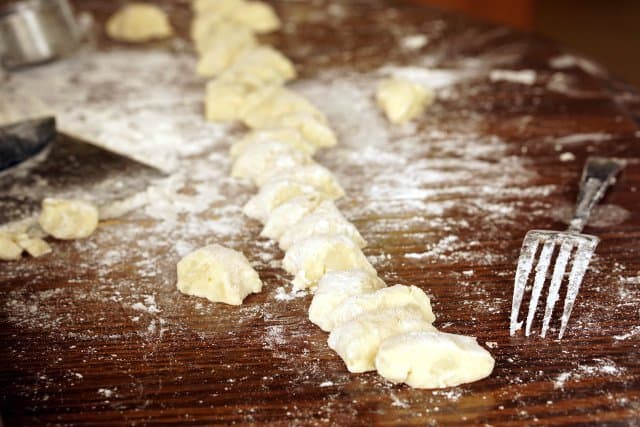 For the spring, we love to serve our homemade gnocchi with pesto and peas. It's the perfect light and flavorful spring dinner recipe! | www.CuriousCuisiniere.com