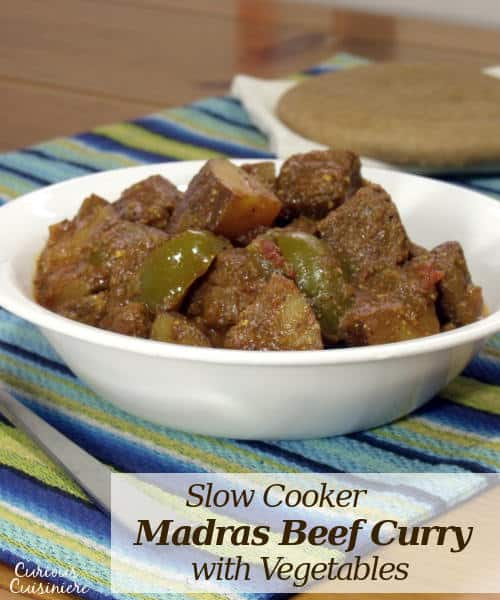 TThis Madras Curry is a warming dish that is perfect for a cool evening. This slow cooker beef curry brings deep flavors and tender meat with little effort. | www.curiouscuisiniere.com