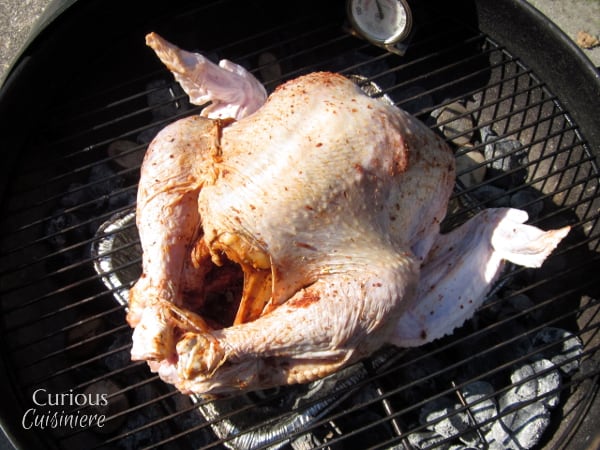 You don't need a smoker to get the great flavor and juicy meat of a Smoked Turkey. We'll show you how to smoke a whole turkey right on your charcoal grill! | www.CuriousCuisiniere.com 