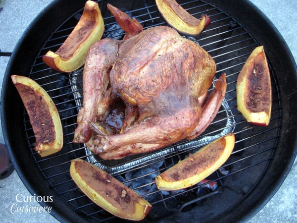 You don't need a smoker to get the great flavor and juicy meat of a Smoked Turkey. We'll show you how to make a smoked turkey on a charcoal grill! | www.CuriousCuisiniere.com 