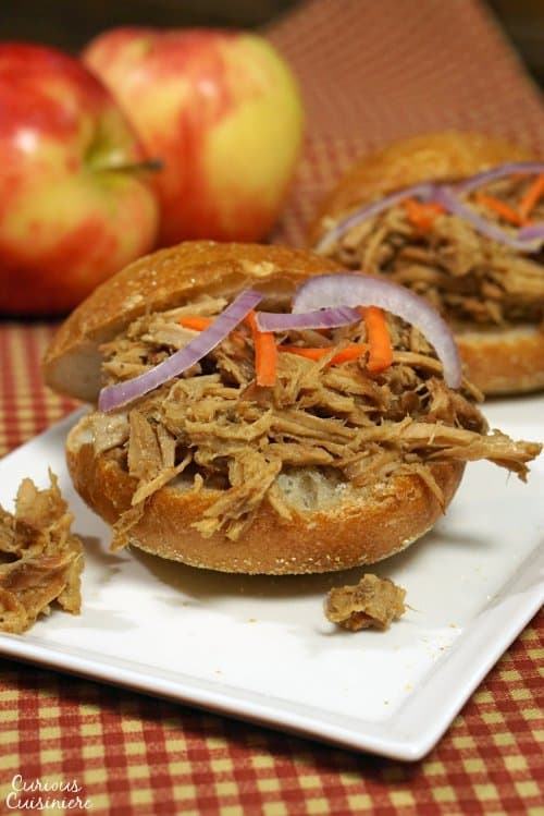 Apple adds sweetness to this slow cooker bourbon pulled pork. This dish makes for great appetizer sliders or an easy main meal! Double (or triple) the recipe to serve a crowd! | www.CuriousCuisiniere.com 