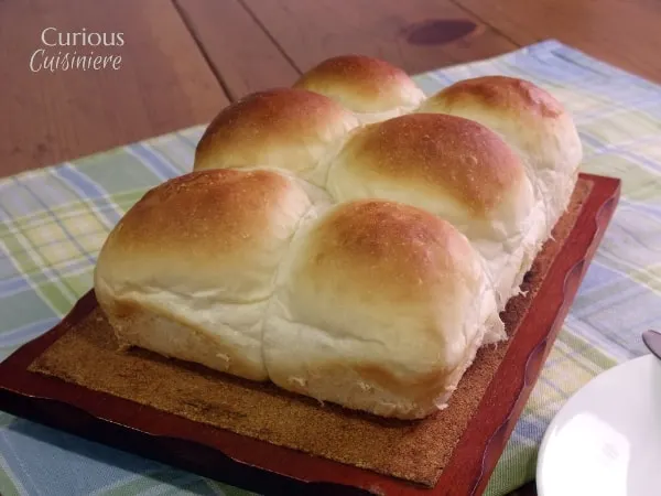 These light and fluffy dinner rolls are easy to make in the bread machine or by hand. Treat your family to something special! | Curious Cuisiniere