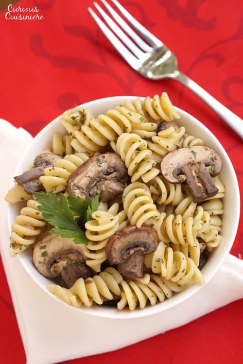 Herbs with a light vinegar dressing give this Mushroom Pasta Salad a bright but earthy flavor. Serve it hot or cold to suit the season. | Curious Cuisiniere