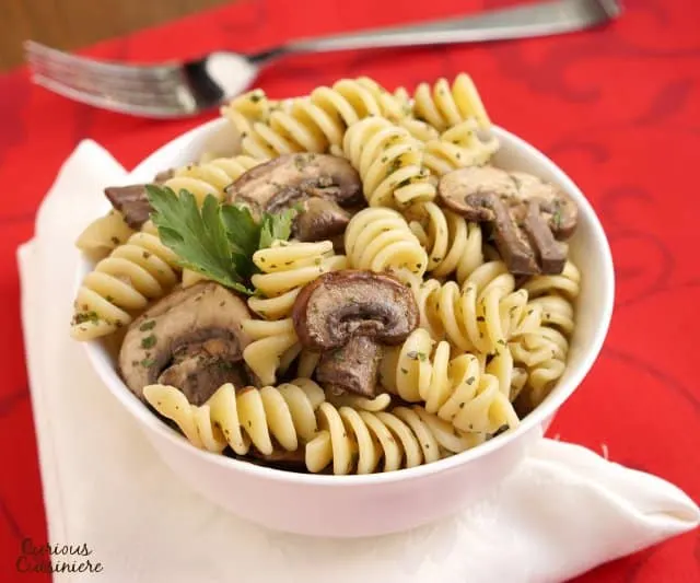 Herbs with a light vinegar dressing give this Mushroom Pasta Salad a bright but earthy flavor. Serve it hot or cold to suit the season. | Curious Cuisiniere