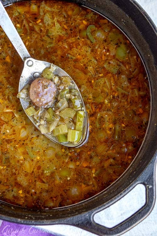 A pot of Cajun Gumbo with andouille sausage. Hearty and comforting. Serve it over rice for a warm and satisfying taste of the Louisiana bayou. | www.CuriousCuisiniere.com