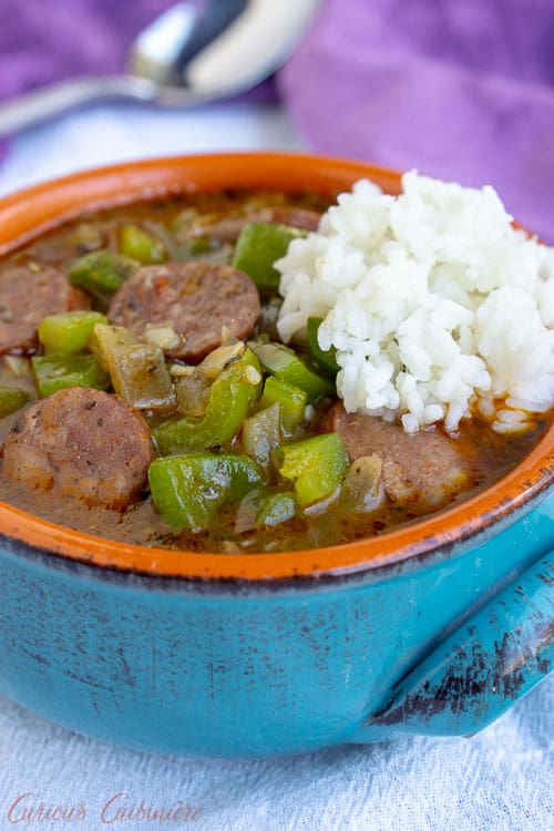 This hearty, recipe for Cajun Gumbo with andouille sausage is served over rice for a warming and comforting taste of the Louisiana bayou. | www.CuriousCuisiniere.com
