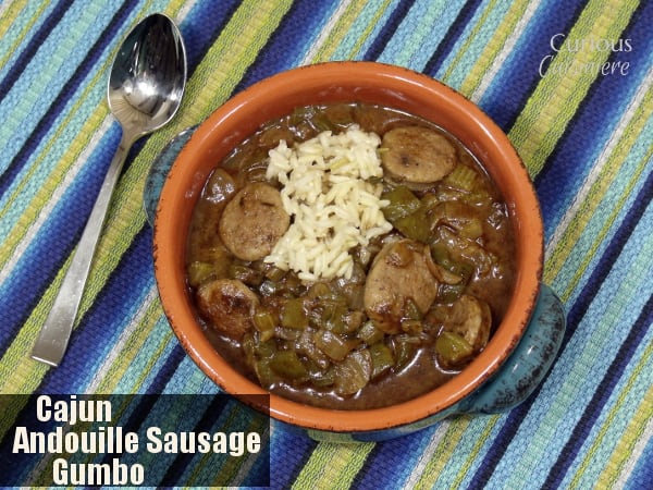 This hearty, Cajun Gumbo with andouille sausage is served over rice for a warming and comforting taste of the Louisiana bayou. | www.CuriousCuisiniere.com