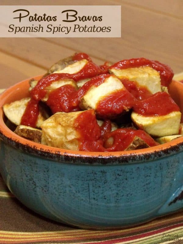 We've lightened up Patatas Bravas, the traditional Spanish tapas dish, by roasting the potatoes and serving it with a traditional spicy tomato-based sauce. | www.CuriousCuisiniere.com