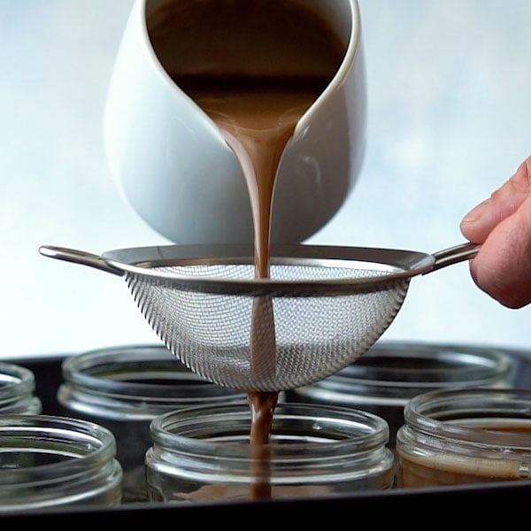 Straining chocolate custard for pots de creme