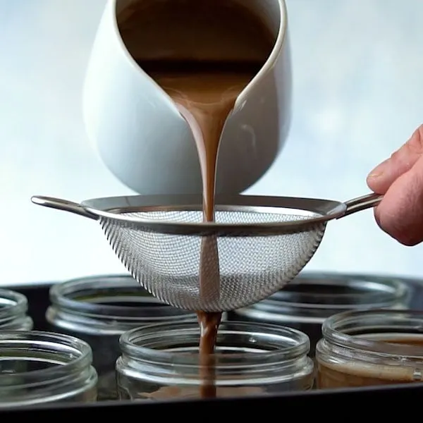 Straining chocolate custard for pots de creme