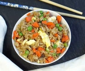 Homemade Vegetable Fried Rice is so flavorful and quick, we're pretty sure you could have it on the table before the delivery driver gets to your door. | www.CuriousCuisiniere.com