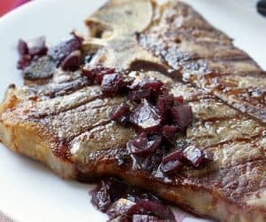 Grilled t-bone steak with red wine sauce.