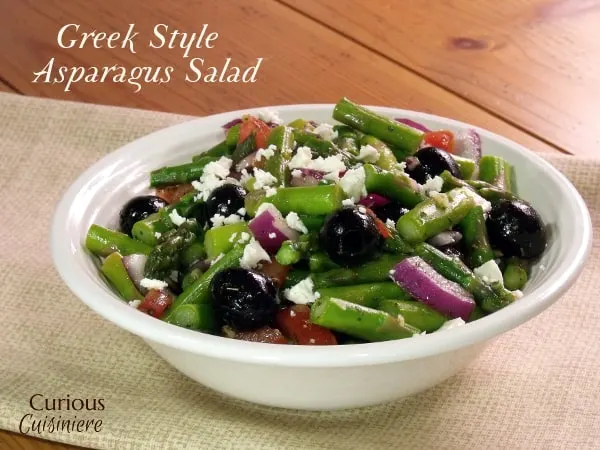 A lemony dressing mingles with crisp asparagus, black olives, and feta cheese in this Greek Asparagus Salad, a recipe that is perfect for spring. - Greek Asparagus Salad from Curious Cuisiniere