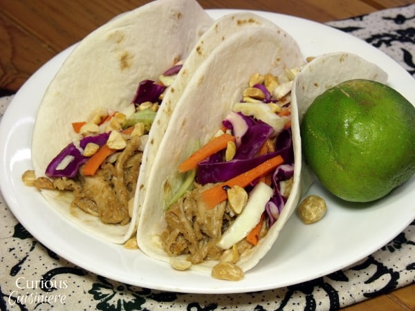 Leftover chicken is given new life with a nutty, Thai peanut sauce and a bright cabbage slaw. - Thai Peanut Chicken Tacos from Curious Cuisiniere