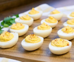 Deviled eggs on a wooden cutting board small image