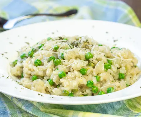Creamy risotto studded with spring green peas and bursting with lemon, and herbs small image.