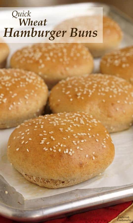 These homemade, wheat hamburger buns go from a pile of ingredients to fluffy, golden buns in less than an hour. | www.CuriousCuisiniere.com
