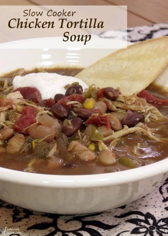 With tender shredded chicken and and lots of veggies, this Slow Cooker Chicken Tortilla Soup is the perfect, easy weeknight recipe. | www.CuriousCuisiniere.com