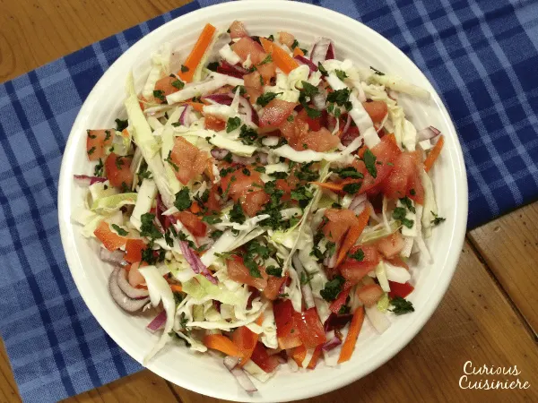 Try something new for your next BBQ or cookout with this crunchy Ensalada de Repolla. The Nicaraguan version of Coleslaw is bright and flavorful with a lime and cilantro vinaigrette.| www.CuriousCuisiniere.com