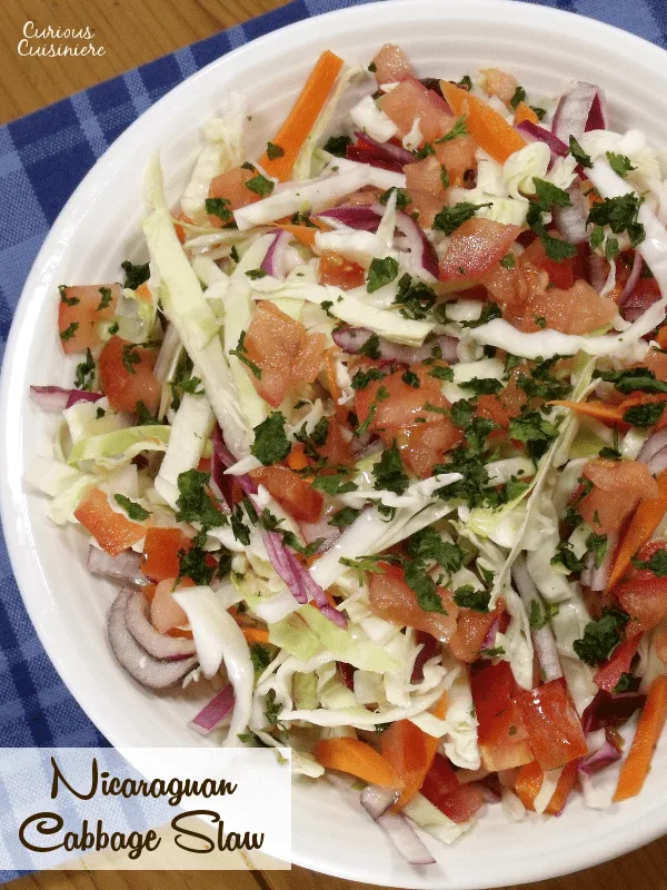 Try something new for your next BBQ or cookout with this crunchy Ensalada de Repolla. The Nicaraguan version of Coleslaw is bright and flavorful with a lime and cilantro vinaigrette.| www.CuriousCuisiniere.com