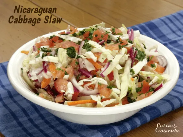Try something new for your next BBQ or cookout with this crunchy Ensalada de Repolla. The Nicaraguan version of Coleslaw is bright and flavorful with a lime and cilantro vinaigrette.| www.CuriousCuisiniere.com 