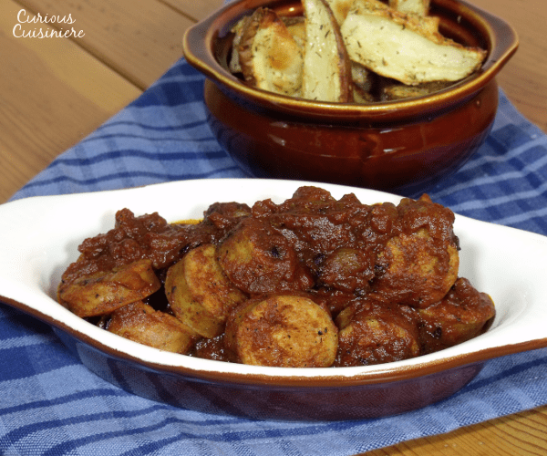 Bratwurst coated in a sweet and spicy curry sauce.