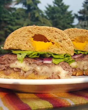 A juicy burger stuffed with gooey cheese is the perfect addition to any summer barbecue or cookout. Fire up the grill!