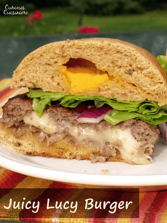 Cheese lovers rejoice! This Juicy Lucy Burger is stuffed with gooey cheese. It's the perfect addition to any summer barbecue or cookout. Fire up the grill! | www.CuriousCuisiniere.com