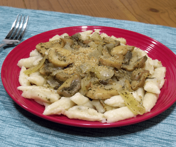 The Polish version of Italian gnocchi. Soft and fluffy potato dumplings delicious topped with cheese or mushrooms.