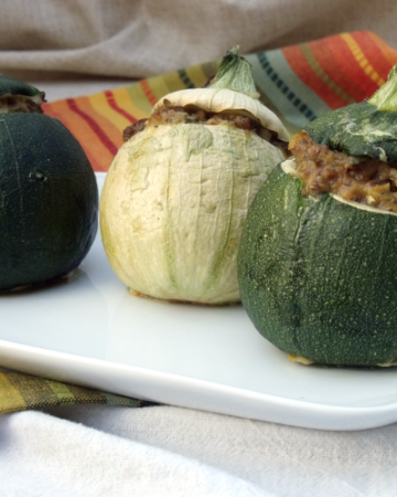 Cute round zucchini are stuffed with a mixture of herbs and sausage. How can you go wrong with zucchini this cute?