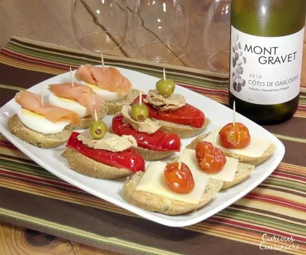 Fun, flavorful ingredients, piled high on a thick baguette slice make for unique appetizers or party food. | www.curiouscuisiniere.com