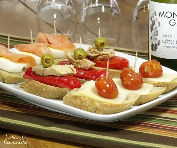 Fun, flavorful ingredients, piled high on a thick baguette slice make for unique appetizers or party food. | www.curiouscuisiniere.com