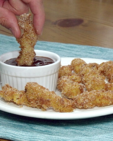 Light and crispy fried churros dipped in a warm, rich chocolate. Perfect for breakfast or an afternoon snack. | www.curiouscuisiniere.com
