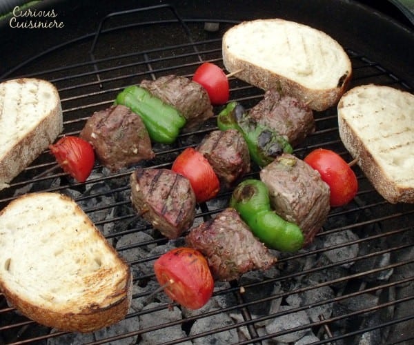 Tender, juicy grilled beef seasoned with garlic and bay, served over thick slices of crusty bread. Big, juicy grill-seared chunks of beef served over thick slices of artisan bread. Espetada, or Portuguese Beef Skewers, is the perfect summer party recipe. | www.CuriousCuisiniere.com 