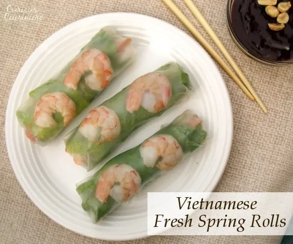 Pork, shrimp, lettuce, fresh herbs, carrots, and rice noodles are wrapped in rice paper, making spring rolls a healthy lunch or snack. Includes detailed instructions on how to wrap and roll a spring roll. | www.curiouscuisiniere.com