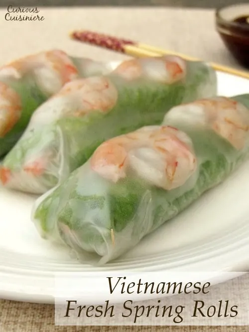 Pork, shrimp, lettuce, fresh herbs, carrots, and rice noodles are wrapped in rice paper, making spring rolls a healthy lunch or snack. Includes detailed instructions on how to wrap and roll a spring roll. | www.curiouscuisiniere.com