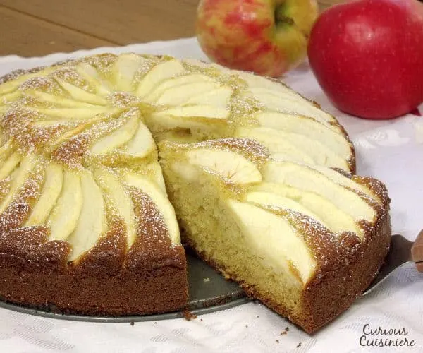 Fluffy and buttery cake topped with apples slices, Apfelkuchen, or German Apple Cake, is a perfect fall dessert. | www.curiouscuisiniere.com